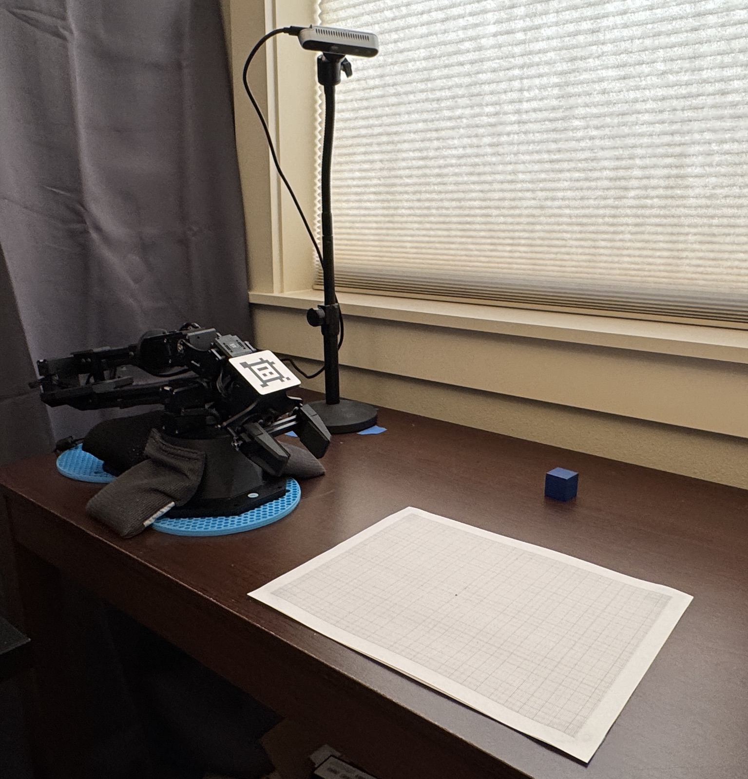 The workspace: WidowX arm, RealSense camera on a stand, and 1mm graph paper